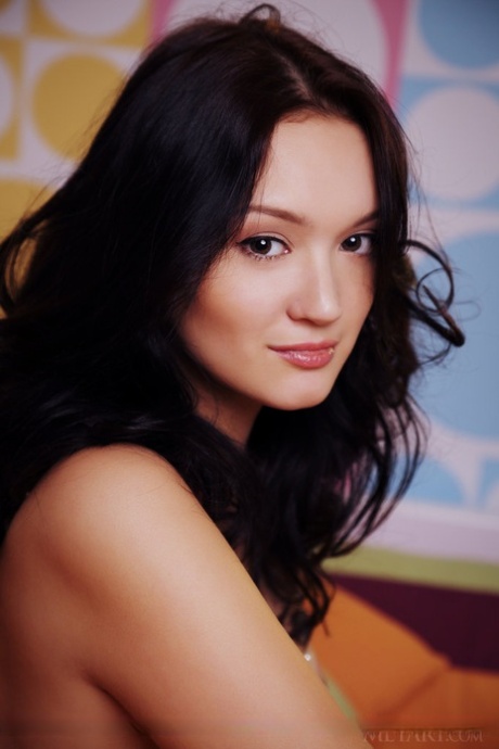 Young beauty with dark hair Ivona Su poses totally naked atop a bed 88163910