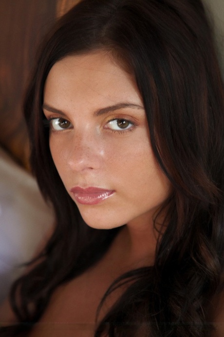 Young brunette Anastasia C poses totally nude while on top of her bed 20103453