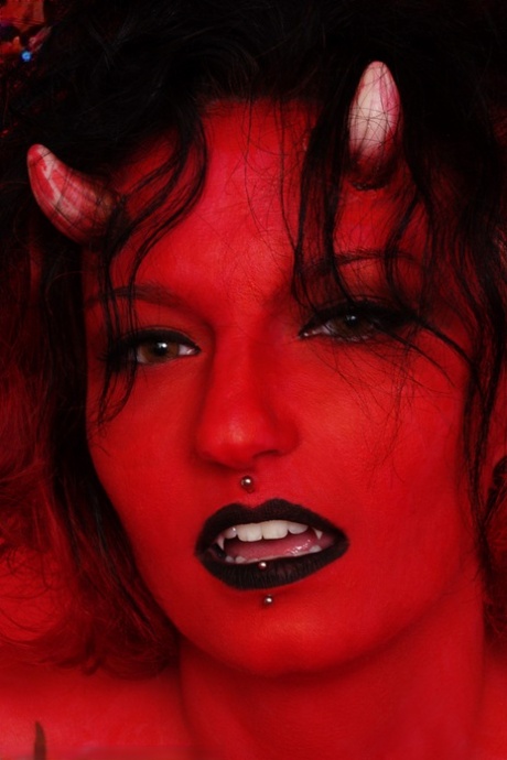 Tattooed and pierced chick Nina Sin sports a devilish look during a nude gig 59462231
