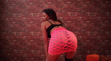 Ebony amateur Roxxi strips to over the knee boots in front of a brick wall 21633674