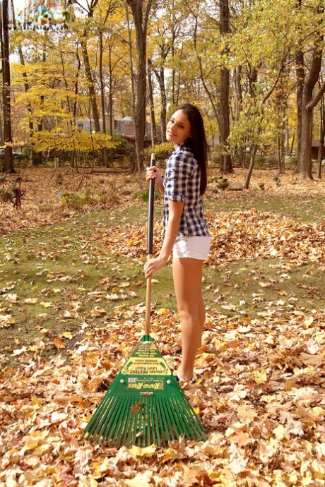 Gorgeous teen covers her beautiful body with leafs in the woods 19429806