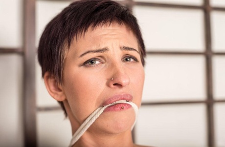 Short haired female sports a message on soles of feet while bound and gagged 94541690