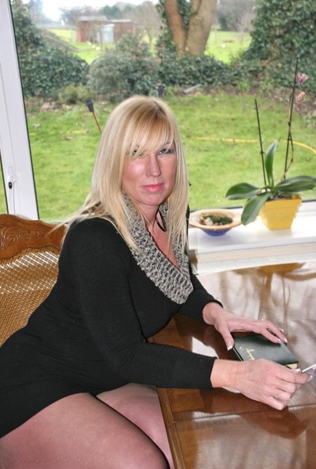 Older blonde amateur Melody sets her firm breasts free in a thong 88639068