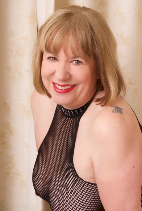 Mature British woman Speedy Bee fingers her cunt after hiking up a mesh dress 35333772