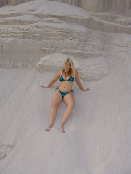 Mature blonde Sweet Susi doffs a bikini to pose naked in a sand pit 45450074