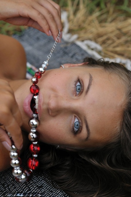 Teen solo girl Katarina B flaunts her slim body and beautiful feet in a field 72356011