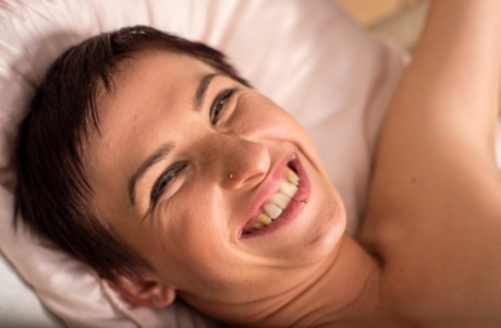 Short haired female struggles against rope restraints in the nude on bed 89807956