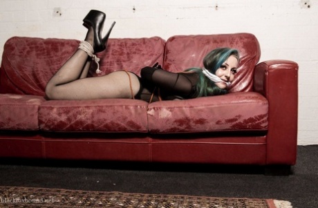 White girl with dyed hair finds herself gagged and hogtied on a chesterfield 75198891