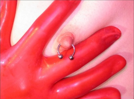 Solo model with a pierced nipples poses in latex and rubber 76037936