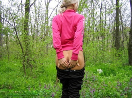 Blonde amateur Adele exposes her boobs and butt while in a forest setting 84447804