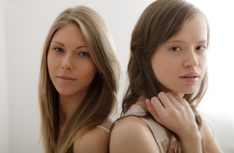 Young looking girls Snejanna and Kitana have lesbian sex atop their bed 85071928