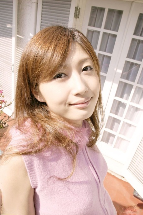 Asian solo girl Mio Komori hides her naked pussy behind a well-placed pear 83385914