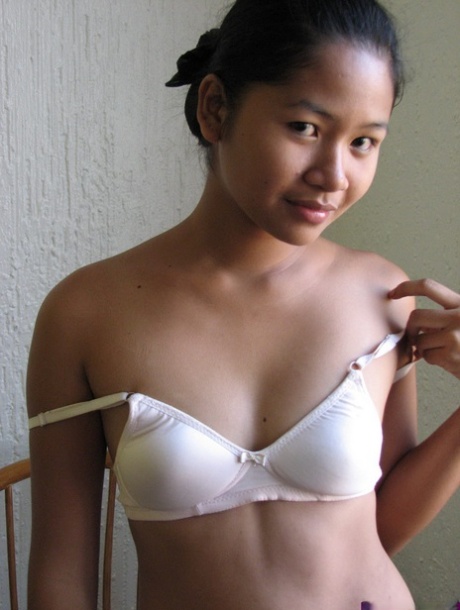 Barely legal Asian girl casually strips off her clothes for nude poses 25717284