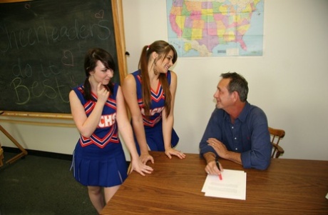 2 cheerleaders jerk off their geography teacher on top of his desk 11291487
