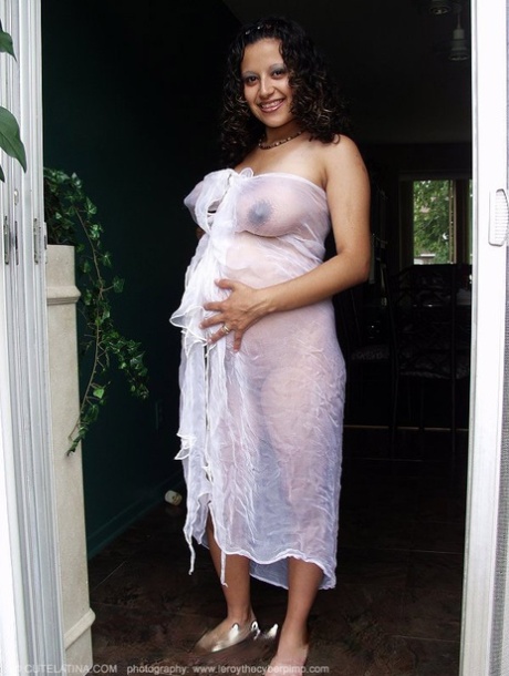Pregnant Latina female show her milk filled tits and belly bump in the nude 62820007