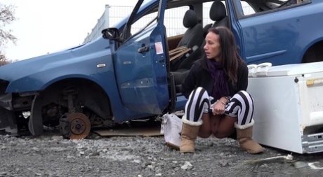 Eveline Neill squats for a piss beside a disabled automobile 98072886