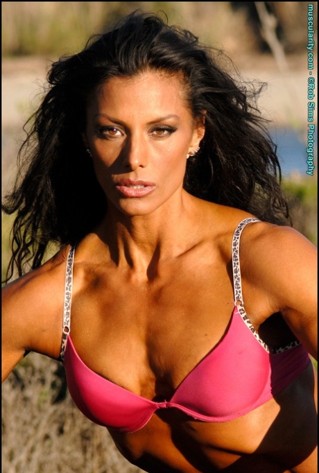 Dark haired bodybuilder Deidre Pagnanelli slips bra straps over her shoulders 48088555