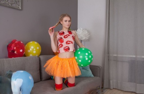 Skinny young girl Lili holds a balloon before getting totally naked 27936734