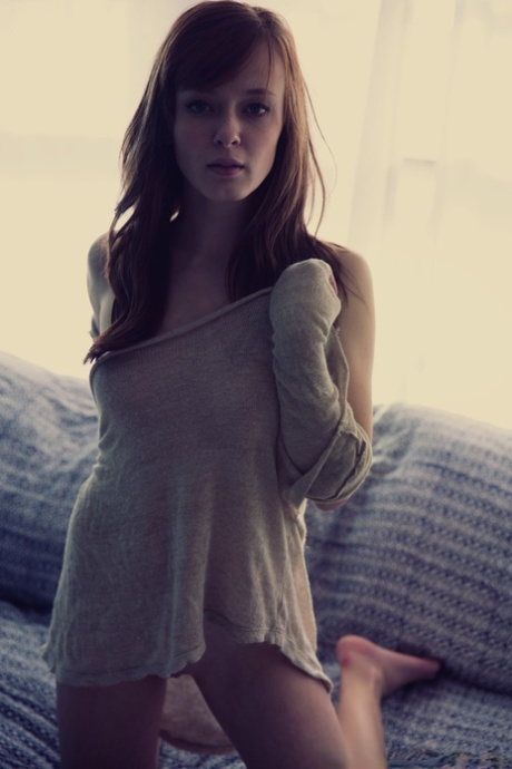 Sexy natural redhead Ellie Jane gets completely naked on a chesterfield 88744364