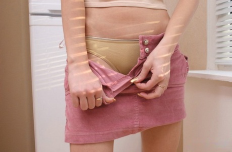 Sweet young girl strips down to her socks while in the confines of her home 64031494