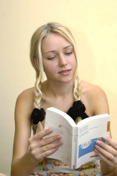 Young blonde displays her firm boobs while sporting braided pigtails 14606173