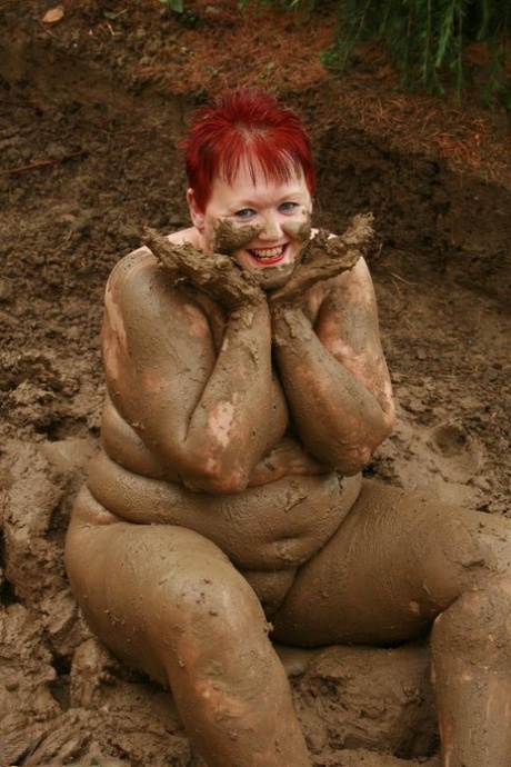 Older redhead Valgasmic Exposed rolls around in a mud pit while totally naked 33671712