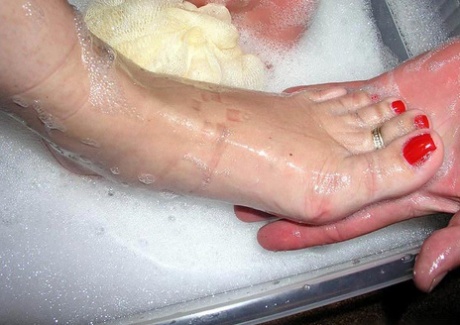 Caucasian woman has her feet washed and sucked on by an older man 45555739