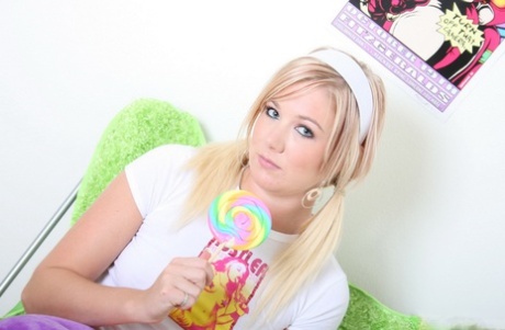 Cute blonde licks a sucker while exposing her tits and pussy in pink socks 78025619