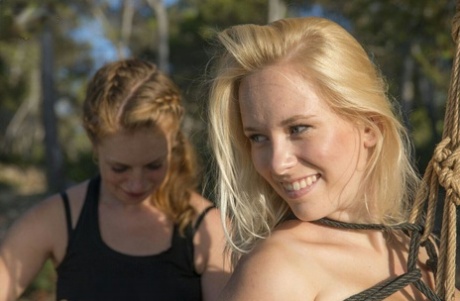 Lesbian women engage is a session of suspension bondage outdoors 57789477