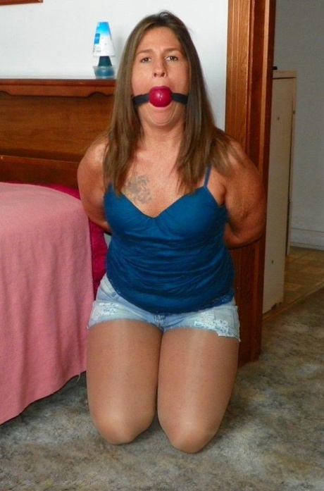 Caucasian girl sports a ball gag while handcuffed and hogtied in her close 47339632