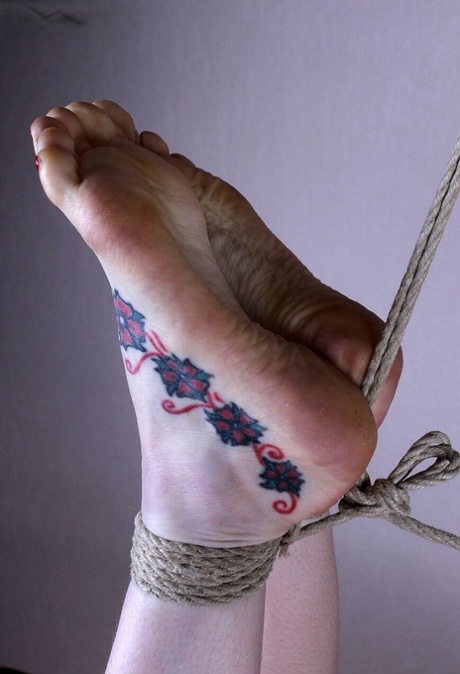 Naked white girl sports tattooed feet while suspended in midair by ropes 79086457