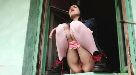 Distressed girl squats in an open window while taking a badly needed pee 79919941