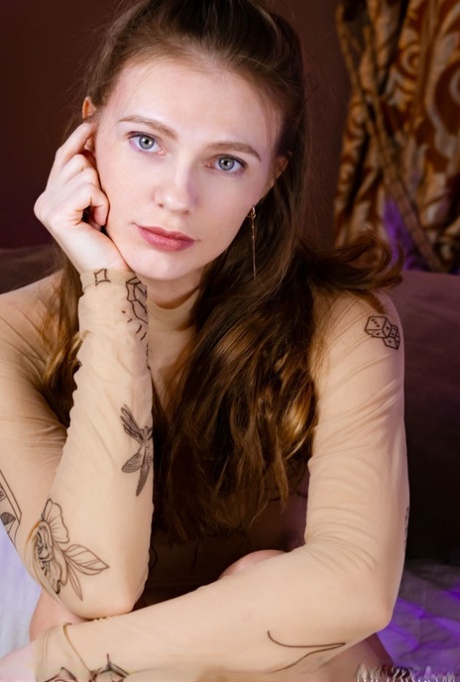 Young beauty with lots of red hair Elina De Leon gets bare naked on a bed 69073823