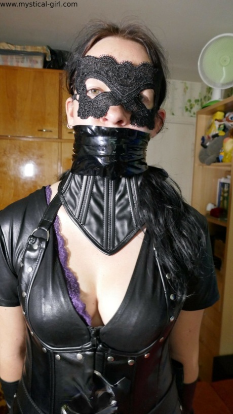 Brunette female models leather clothing while wearing a mask 41509732