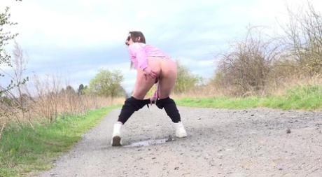 Solo girl Barbara Bieber pulls down her leggings to pee on a country road 17953566