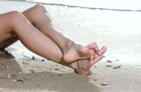 Girl next door type Dzhili takes a nude romp in the ocean during solo action 14176922