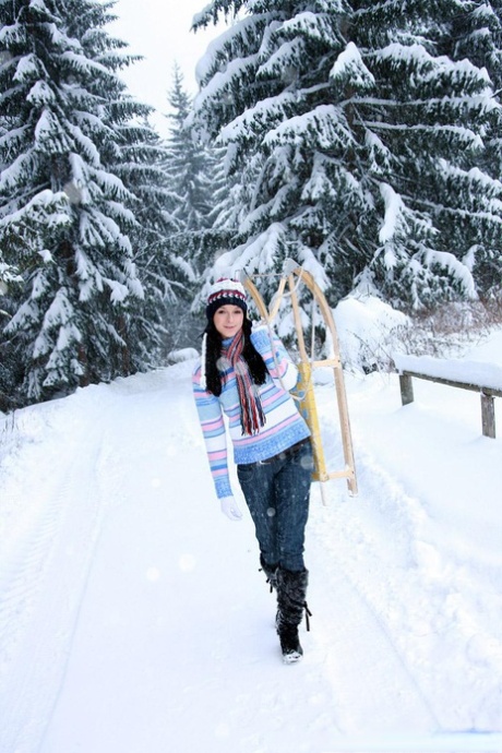 Young looking girl masturbates on a sled with a toy on a winter's day 69813339