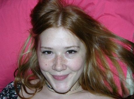 Young redhead Harper grabs her butt while showing her trimmed muff on a bed 11731030