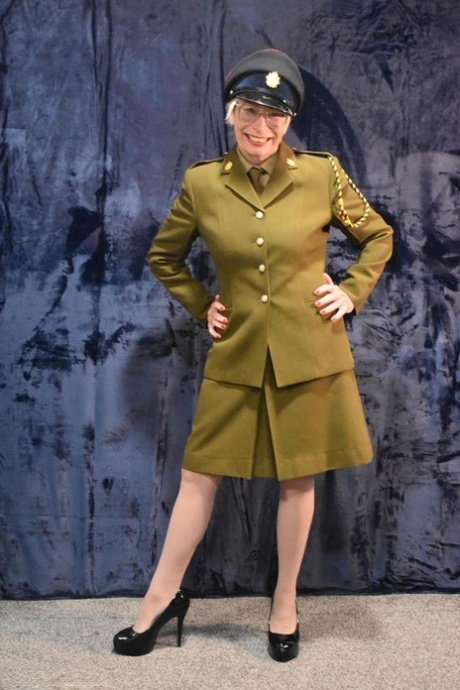 Older military lady Barby Slut starts to take off her uniform 10860576