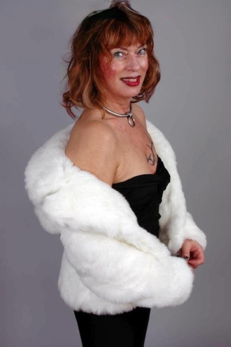 Older redhead Gabriella models an off shoulder black dress during SFW action 15240867