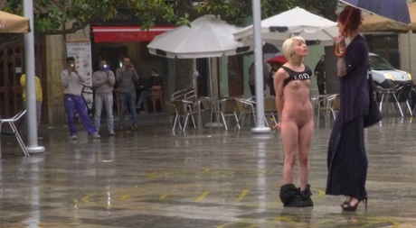 Blonde girl is humiliated in public on a rainy day before public sex acts 91640883