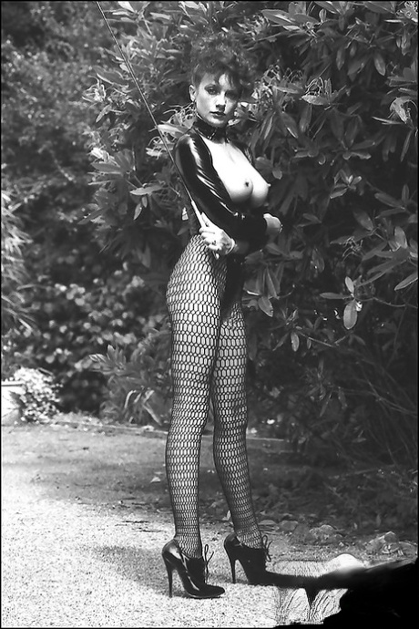 Leggy lady in fetish outfit exposing her boobs in vintage photo set 74250823