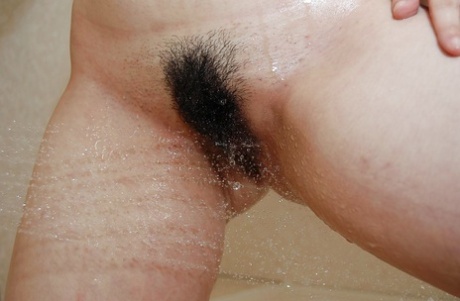 Naughty asian MILF rubbing her soapy curves in the shower 31954667