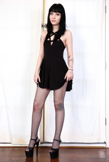 Brunette chick Charlotte Sartre poses in fishnet pantyhose showing juicy holes 44060756